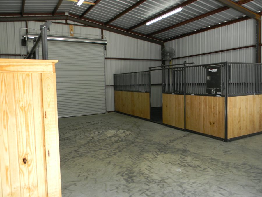 Horse barn interior — custom carpentry and stained concrete floors, East Texas