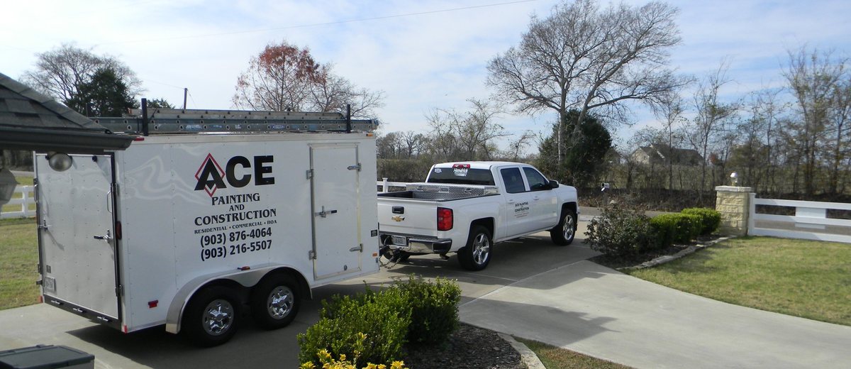Ace Painting and Construction truck and trailer at an East Texas job site